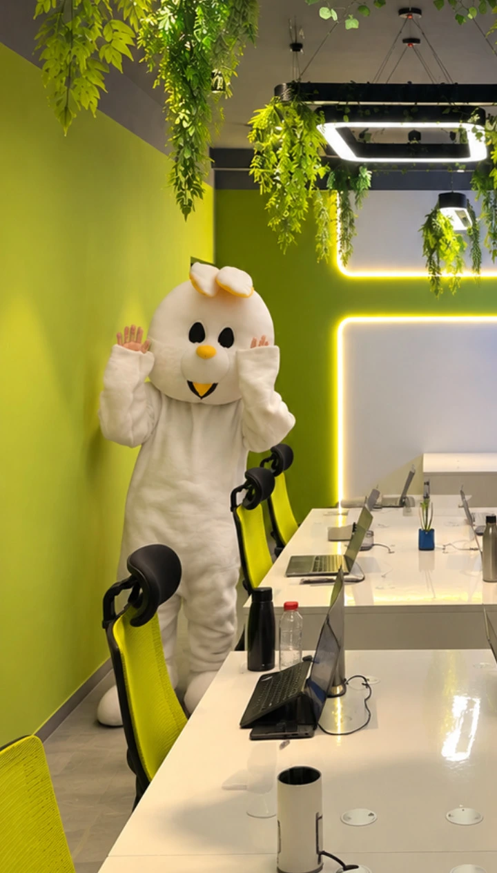 The Cozmic Rabbit mascot waving to children at a street crossing